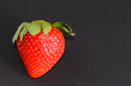 Fresh Ripe Strawberry Fruit on a Black Backgroundの写真素材