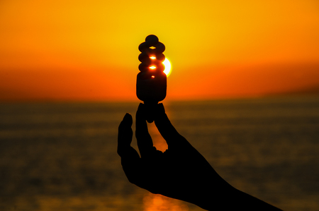 Energy Concept Light Bulb and Sun Setting on the Atlantic Oceanの写真素材