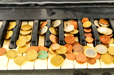 Photo picture close-up of piano keys keyboard and coin moneyの写真素材