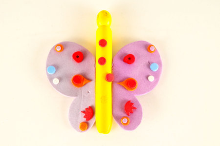 Close-up of plastic colored toy butterfly Object on a White Backgroundの写真素材