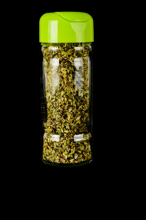 Close-up of oregan spice bottle Object on a Black Backgroundの写真素材