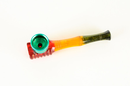 Smoking colored plastic pipe on a white backgroundの写真素材