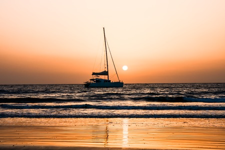 Photo Picture of a Sail Boat Silhouette  at Sunsetの写真素材