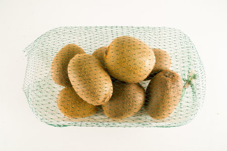 Kiwi in a box isolated on white backgroundの写真素材