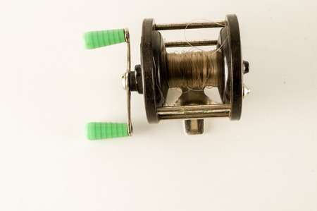 Close-up of Fishing reel Object on a White Backgroundの写真素材