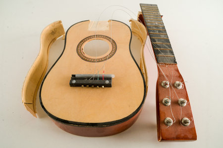 Close-up of Broken Guitar Object on a White Background