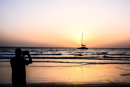 Photo Picture of a Sail Boat Silhouette  at Sunsetの写真素材