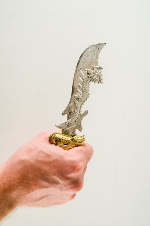 Close-up of oriental knife sword toy Object on a White Backgroundの写真素材