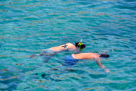 People Enjoying snorkelling with clear cold blue waterの写真素材
