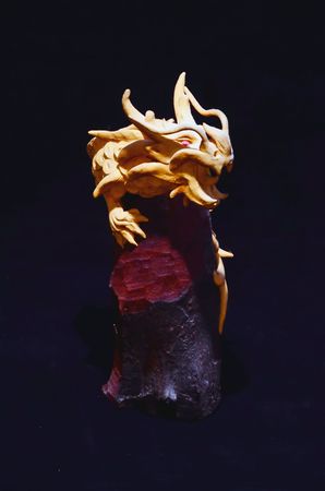 Wood Handmade Statue of a Dragon on Black Backgroundの写真素材