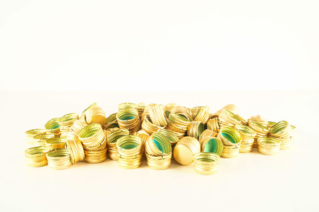 Pile of bottle metal screw caps as pattern background textureの写真素材