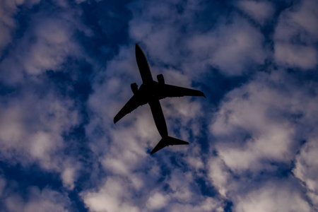 Photo picture Silhouette airplane flying on the sky