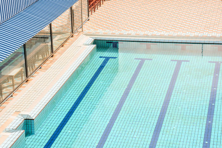 Backyard rectangular blue swimming pool in beautiful park