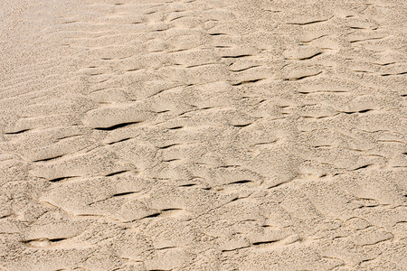 Photo picture closeup sand texture pattern of a beach in the summerの写真素材
