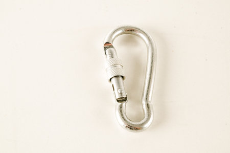 Metal aluminum snap hook isolated background Safety lock carabiner for rope climbing
