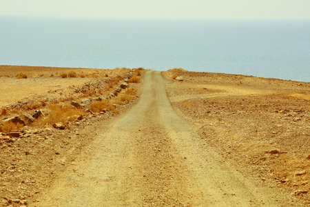 Photo Picture of a Dirt road leading off into the desertの写真素材