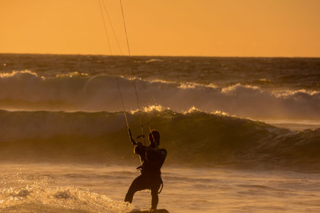 Single surfer at sunset on a calm ocean