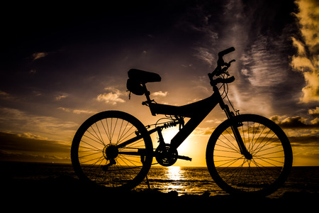 Photo Picture of a Mountain Bike Silhouette at Sunsetの写真素材