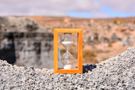 Conceptual Photo Picture of an Hourglass Object in the Dry Desertの写真素材