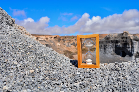 Conceptual Photo Picture of an Hourglass Object in the Dry Desertの写真素材