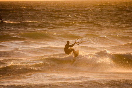 Single surfer at sunset on a calm ocean