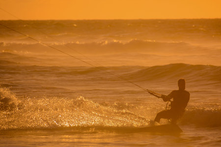 Single surfer at sunset on a calm oceanの写真素材