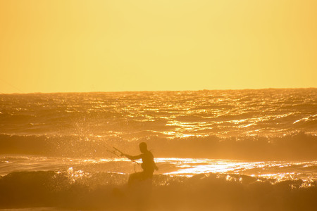 Single surfer at sunset on a calm oceanの写真素材