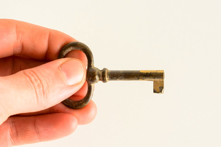antique golden door key isolated on white backgroundの写真素材