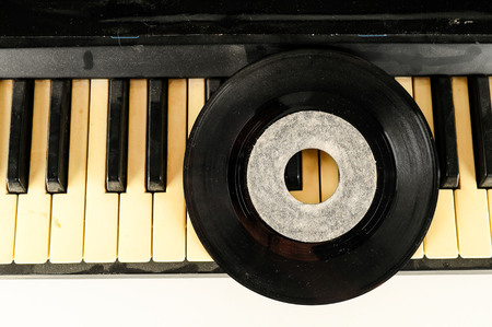 Photo picture close-up of piano keys keyboard and vinyl disk recordの写真素材