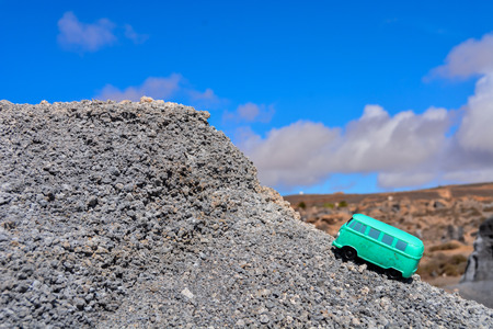 Conceptual Photo Picture of a toy car in the dry desertの写真素材