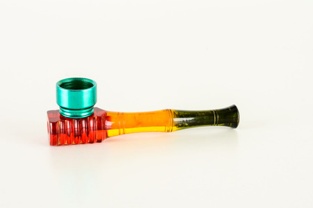 Smoking colored plastic pipe on a white backgroundの写真素材