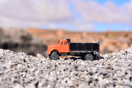 Conceptual Photo Picture of a toy car in the dry desertの写真素材