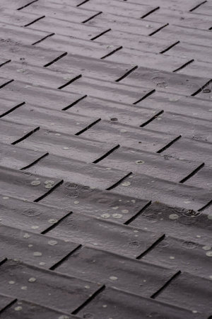 Photo picture texture background of Modern tiles roof in the rain