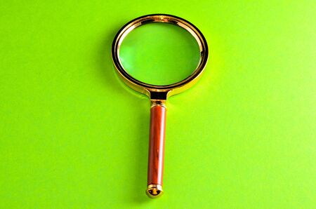 Vintage Magnify Glass Loupe on a Colored Backgroundの写真素材
