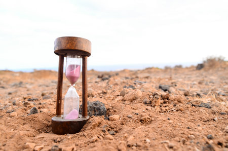 Time Concept Hourglass on the Rock Desert