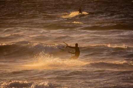 Single surfer at sunset on a calm oceanの写真素材
