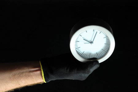 Clock And an Hand on a Black Background