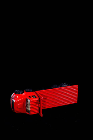 Red Toy Figurine Truck on a Black Background