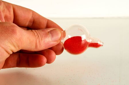 Close-up of broken hourglass Object on a White Backgroundの写真素材