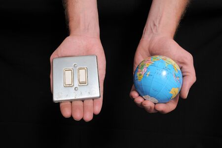 An Hand Holding a Globe over a Black Backgroundの写真素材