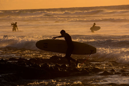 Surfer at sunset on a calm ocean