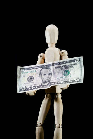 wooden dummy and five dollars banknote, business concept, puppet made of wood, art mennequin.Wooden Dollの写真素材