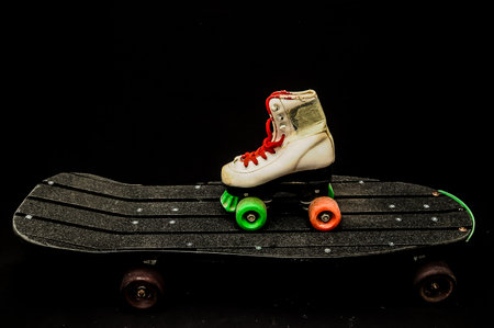 Vintage Style Black Skateboard and Skate Boot on a Dark Backgroundの写真素材