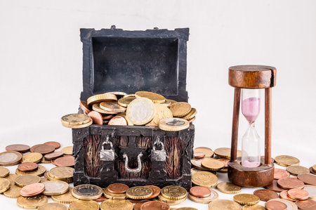 A wooden chest full of coins and a sand timer, real image