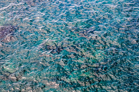 The water is blue and has a lot of bubbles. The bubbles are small and scattered throughout the water