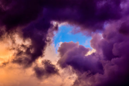 The sky is filled with dark clouds and a blue sky. Scene is somber and foreboding