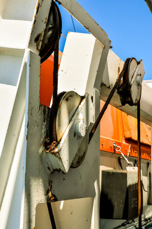 A rusty chain is attached to a white object
