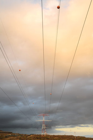 Power Electric Tower on a Cloudy Sky at Sunset