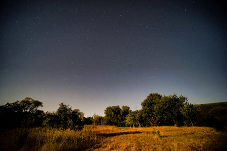 sunset over the field, night sky with stars, wide angle viewの写真素材