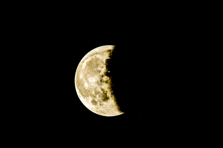 A large moon is in the sky, with a dark background. The moon is the main focus of the image, and it...